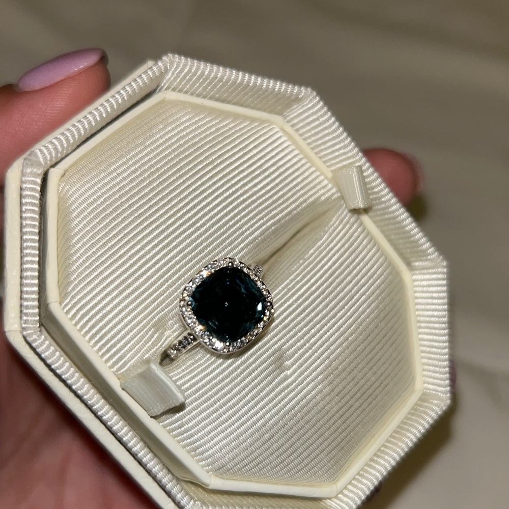 Cubic zirconia size 8 ring.  Purchased from kohls.  dark teal center stone